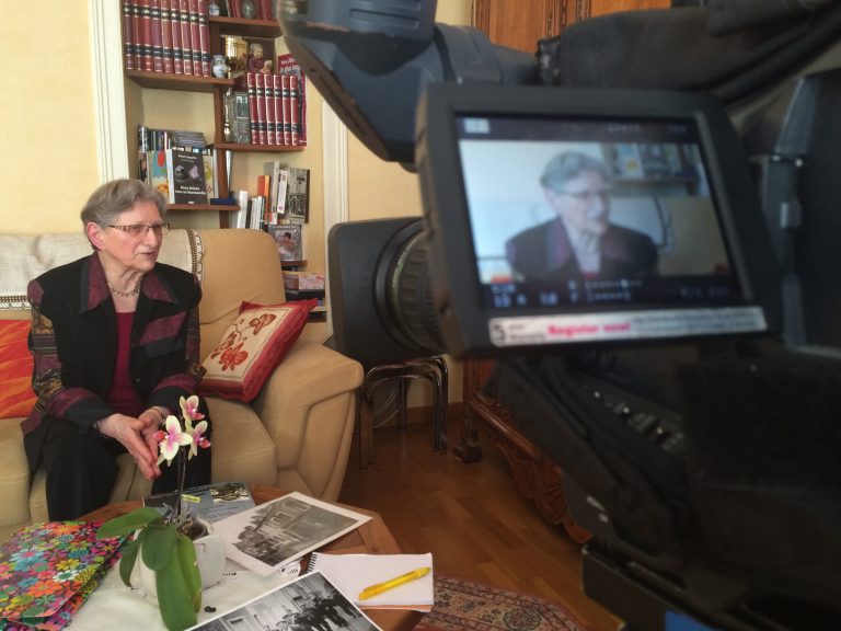 In this photo dated May 14, 2014, Andree Auvray answers question during an interview with the Associated Press in Sainte Mere Eglise in Normandy, France. Andree Auvray, nine months pregnant, was hiding from German bombings in a Normandy ditch with her husband one night in June 1944 when their dogs started barking. The shadows of three soldiers appeared. The soldiers were Americans. D-Day had begun. Auvray relives that wrenching time with clarity and a growing sense of urgency. Seventy years have passed since the Allied invasion of Normandy helped turn the tide against Hitler. With their numbers rapidly diminishing, she and other French women and men who owe their freedom to D-Day's fighters are more determined than ever to keep alive the memory of the battle and its meaning. (AP Photo/Nicolas Garriga)