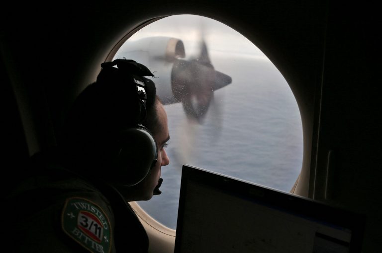 Flight officer Rayan Gharazeddine on board a Royal Australian Air Force AP-3C Orion, searches for the missing Malaysia Airlines Flight MH370 in southern Indian Ocean, Australia, Saturday, March 22, 2014.  A satellite image released by China on Saturday offers the latest sign that wreckage from a Malaysia Airlines plane lost for more than two weeks could be in a remote stretch of the southern Indian Ocean where planes and ships have been searching for three days.  (AP Photo/Rob Griffith, Pool)