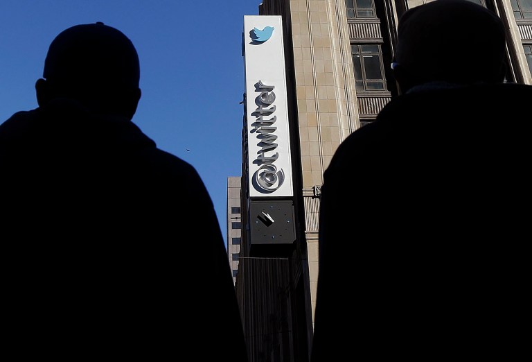 FILE - In this Monday, Nov. 4, 2013, file photo, pedestrians cross the street in front of Twitter headquarters in San Francisco. Twitter on Tuesday, Oct. 7, 2014 filed a lawsuit against the FBI and the Department of Justice to be able to release more information about government surveillance of its users. (AP Photo/Jeff Chiu, File)