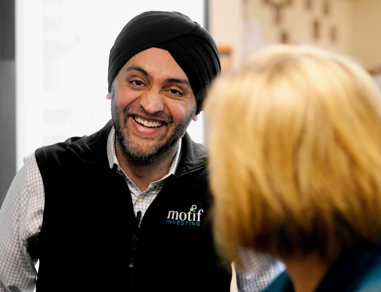 FILE - In this March 18, 2014 file photo, Hardeep Walia, founder of Californa-based Motif Investing, talks with staff members during a visit to Oak Grove Middle School in Fargo, N.D. Companies that provide hydraulic fracturing technologies and other services in the North Dakota oil patch and elsewhere aren't the only ones making money. Motif, an online brokerage service that offers baskets of stocks based on a single theme, has had whopping successes with 