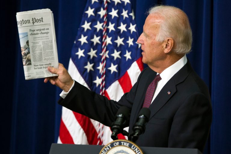 Vice President Joe Biden holds up a copy of the Washington Post as he speaks at the White House Clean Energy Investment Summit in the South Court Auditorium on the White House campus, on Tuesday, June 16, 2015, in Washington. (AP Photo/Evan Vucci)