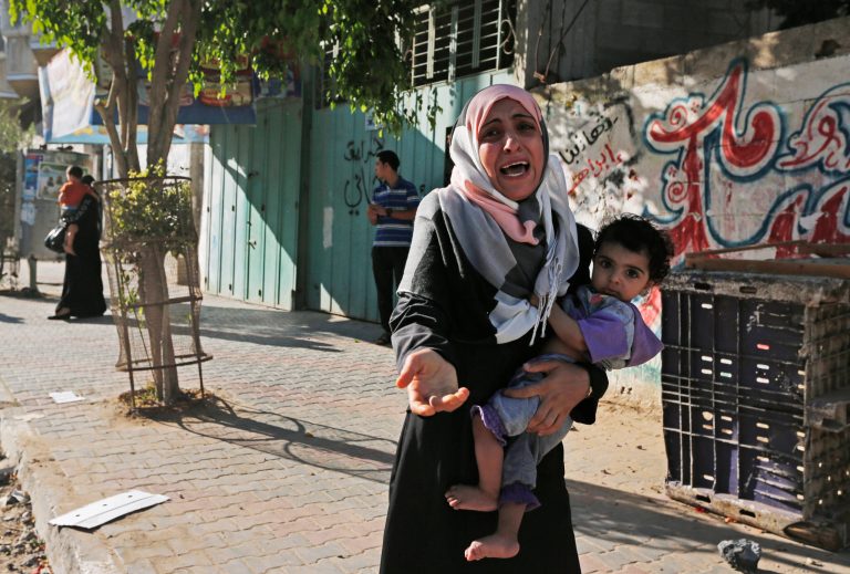 A woman cries as Palestinians flee their homes in the Shajaiyeh neighborhood of Gaza City, after Israel had airdropped leaflets warning people to leave the area, Wednesday, July 16, 2014. A Hamas website says Israel has fired missiles at the homes of four of its senior leaders as it resumed bombardment of Gaza, following a failed Egyptian cease-fire effort. Health officials say the Palestinian death toll in nine days of fighting has reached 204. (AP Photo/Lefteris Pitarakis)