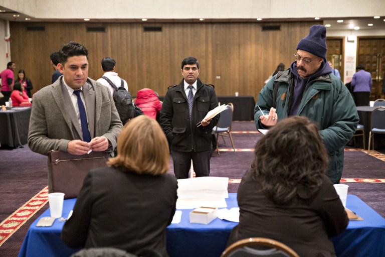 A jobs speak with recruiters during a National Career Fairs job fair in Chicago, on Thursday, Jan. 14. (Daniel Acker/Bloomberg)