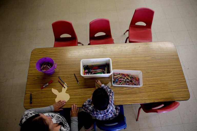 In this April 14, 2014 photo, preschool teacher Arene Galirza, left, a 4-year-old student color a rabbit-shaped paper cutout at Community Day Preschool of Garden Grove, in Garden Grove, Calif. According to the school's executive director Sue Puisis, the enrollment at the preschool has dropped by more than 50 percent since 2008. The financial crisis that followed the collapse of U.S. investment bank Lehman Brothers in 2008 sent birth rates tumbling around the world as couples found themselves too short of money or too fearful about their finances to have children. Six years later, birth rates haven't bounced back.  (AP Photo/Jae C. Hong)