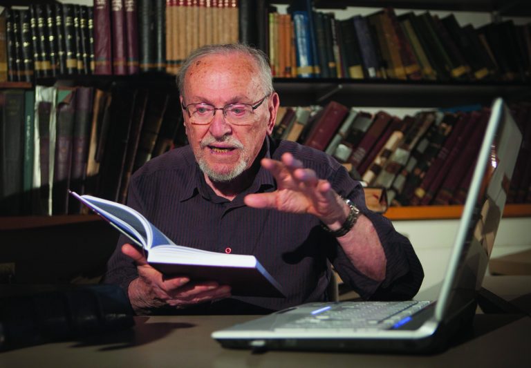 A Tuesday, July 31, 2012 photo, shows biblical scholar Professor Menachem Cohen, reading from a book, at the library of Bar Ilan University, outside Tel Aviv, Israel. For the past 30 years the 84-year-old Judaic biblical scholar has been immersed in a Sisyphean task of correcting all known errors in Jewish scripture to produce a definitive edition of the Hebrew Bible. Now, thanks to the internet, he's bringing it to the general public like never before with a sophisticated search engine that allows even novices to explore the holy text with ease.(AP Photo/Dan Balilty)