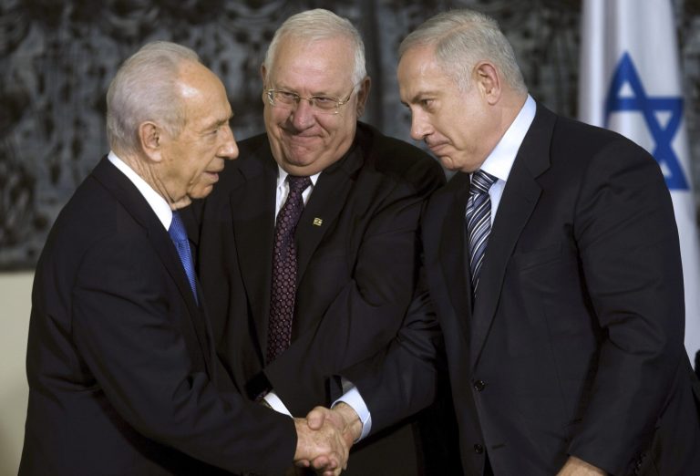 FILE - In this April 1, 2009, file photo, Israeli President Shimon Peres, left, greets Israeli Prime Minister Benjamin Netanyahu, right, as Knesset speaker Reuven Rivlin stands near during a handover ceremony at Peres' residence in Jerusalem. A nasty race to succeed Shimon Peres as Israel's head of state is finally coming to an end on Tuesday, June 10, 2014, with five candidates facing off in parliament over the right to become the country's next president. (AP Photo/Menahem Kahana, Pool, File)