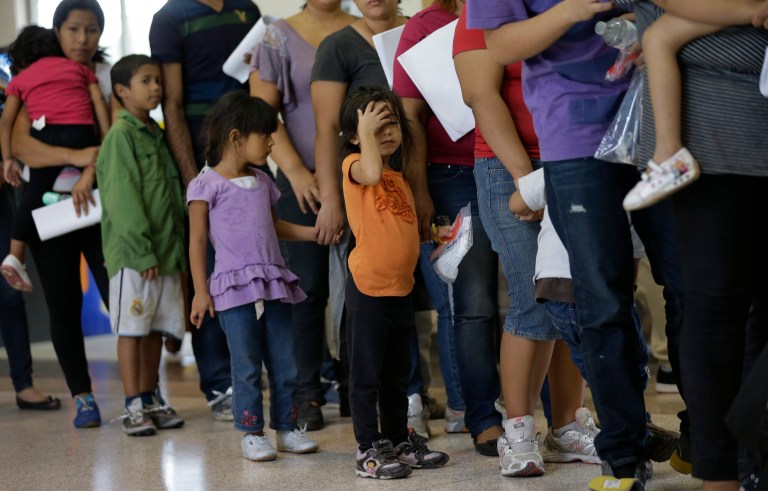 FILE - In this June 20, 2014 file photo, immigrants who entered the U.S. illegally stand in line for tickets at the bus station after they were released from a U.S. Customs and Border Protection processing facility in McAllen, Texas. Tackling what he has called a humanitarian crisis, President Barack Obama on Tuesday, July 8, 2014 asked Congress for $3.7 billion to cope with a tide of minors from Central America who are illegally crossing the U.S. border, straining immigration resources and causing a political firestorm in Washington.  (AP Photo/Eric Gay, File)