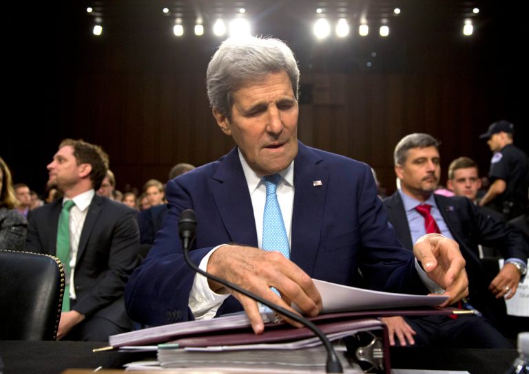 Secretary of State John Kerry settles into his seat as he arrives to testify on Capitol Hill in Washington, Wednesday, Sept. 17, 2014, during a Senate Foreign Relations Committee hearing on the US strategy to defeat the Islamic State group. (AP Photo/Carolyn Kaster)