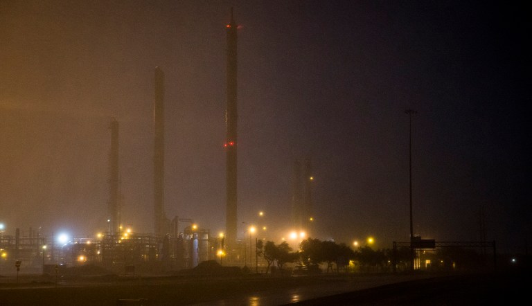 An oil refinery's lights illuminate rainfall as Hurricane Harvey makes landfall in Corpus Christi, Texas, on Friday. Exxon filed a report Tuesday with Texas environmental regulators saying its Baytown refining facility -- the second-largest in the country -- sustained damage after it became 