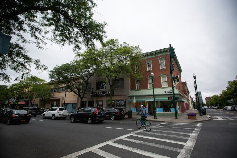 A cyclist passes in front of Liebman's store on Main Street in New Rochelle, N.Y. The leaders of small and mid-size companies are increasingly optimistic about the state of the U.S. economy and their own abilities to increase sales, according to a new survey by JPMorgan Chase.