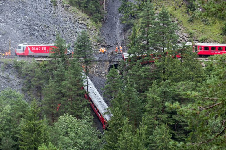 A derailed passenger train is pictured near Tiefencastel, Switzerland, Wednesday, Aug. 13, 2014. A passenger train traveling from St Moritz to Chur in eastern Switzerland has been derailed by a landslide, injuring nearly one dozen passengers, several of them seriously. (AP Photo/Keystone, Arno Balzarini)