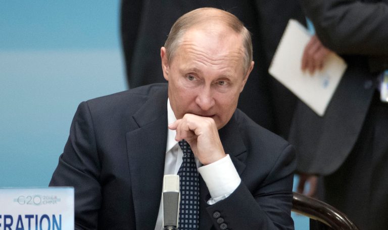 Putin's agents are using cybertools to hack into the political process and spread disinformation, report says. (AP Photo/Mark Schiefelbein, Pool)