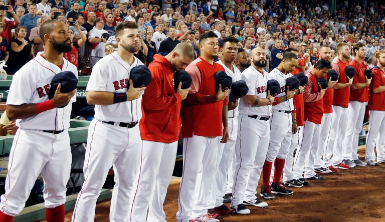 The Boston Red Sox stand for the national anthem before a baseball game against the Toronto Blue Jays in Boston, Monday, Sept. 25, 2017. (AP Photo/Michael Dwyer)