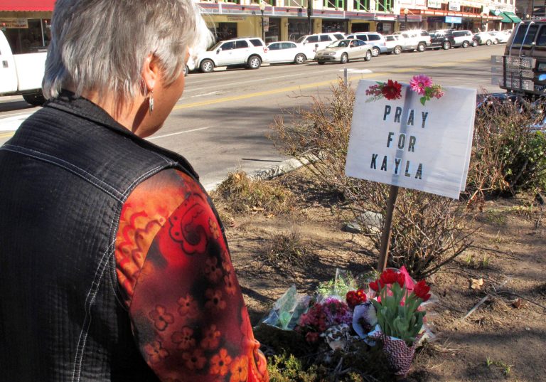 Laura Spaeth looks at a memorial honoring American hostage Kayla Mueller on the corner of courthouse plaza in Prescott, Ariz., Tuesday, Feb. 10, 2015. (AP Photo)Â 
