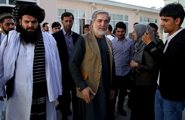 Afghanistan's presidential candidate Abdullah Abdullah, center, leaves after a news conference in Kabul, Afghanistan, Monday, June 23, 2014. Afghanistan's chief electoral officer resigned Monday in a bid to resolve a political crisis over allegations of massive fraud in the runoff presidential vote earlier this month. (AP Photo/Massoud Hossaini)