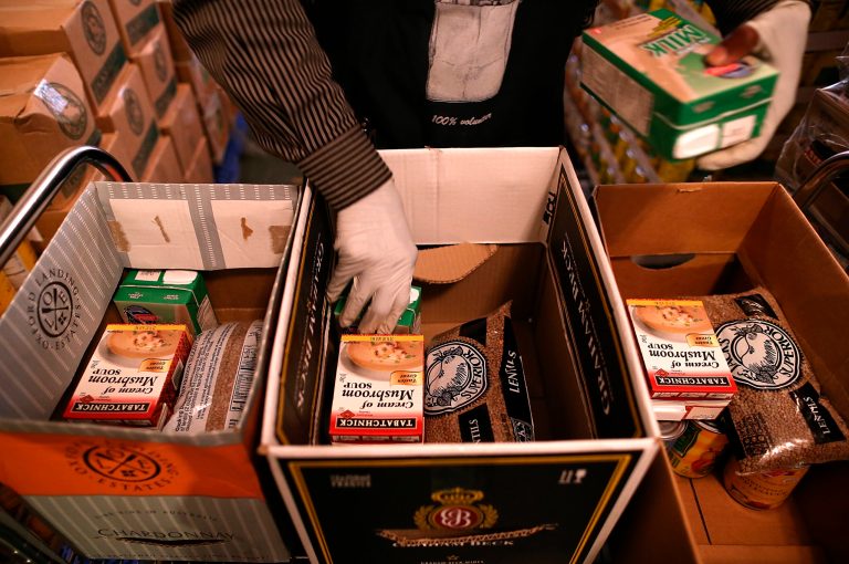 Richmond Emergency Food Bank volunteer Abdul Olorode packs boxes with food to be handed out to needy people on Nov. 1, 2013 in Richmond, Calif. An estimated 47 million Americans saw their food stamp benefits cut as temporary relief to the federal program ends with no new budget from Congress to replace it. Under the new Supplemental Nutrition and Assistance Program, a family of four that used to receive $668 per month will see that amount cut by $36. (Photo by Justin Sullivan/Getty Images)