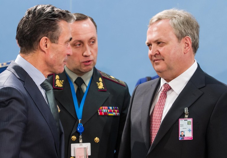 NATO Secretary General Anders Fogh Rasmussen, left, talks with Ukraine's acting Defense Minister Oleksandr Oliinyk, right, prior to the start of a meeting of NATO defense ministers and NATO-Ukraine Commission at NATO headquarters in Brussels on Thursday, Feb. 27, 2014. NATO defense ministers, in a second day of meetings, will discuss the situation in Ukraine and Afghanistan. (AP Photo/Geert Vanden Wijngaert)