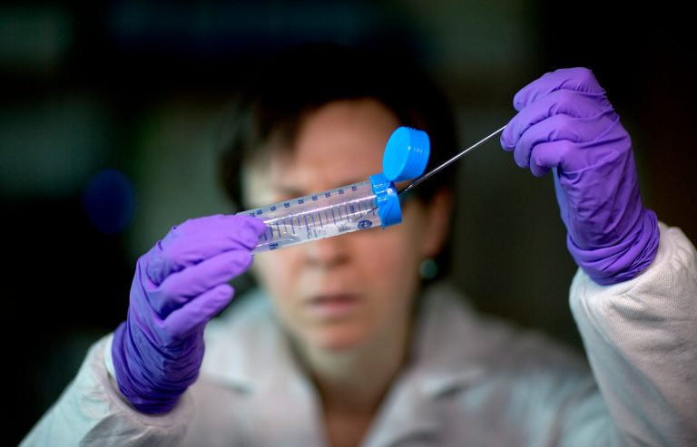 This photo taken Nov. 25, 2013 shows microbiologist Dr. Molly Freeman pulling Listeria bacteria from a tube to be tested for its DNA fingerprinting in a foodborne disease outbreak lab at the federal Centers for Disease Control and Prevention in Atlanta. The nation's disease detectives are beginning a program to try to outsmart outbreaks by routinely decoding the DNA of deadly bacteria and viruses. The initial target: Listeria, a kind of bacteria that's the third-leading cause of death from food poisoning, and one that's especially dangerous to pregnant women. Already, the technology has helped to solve a small listeria outbreak that killed one person in California and sickened seven others in Maryland.(AP Photo/David Goldman)