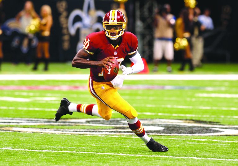 Bill Haber/AP
Robert Griffin III became the first player in NFL history to finish with at least 300 yards passing, two TDs and no picks in his debut.