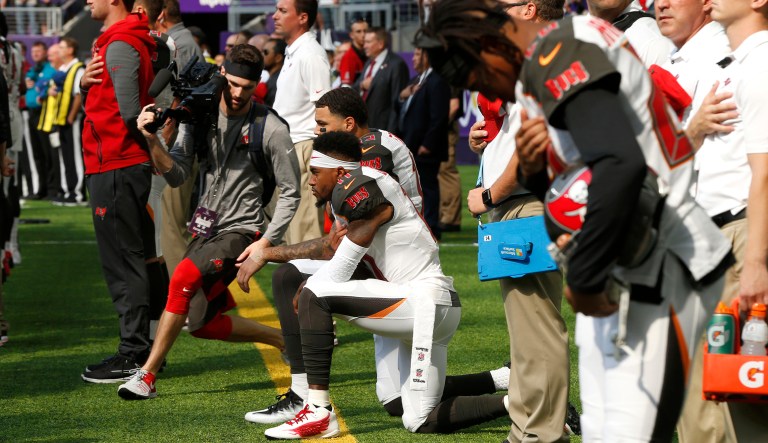 Tampa Bay Buccaneers wide receiver DeSean Jackson, center, takes a knee during the national anthem before an NFL football game against the Minnesota Vikings, Sunday, Sept. 24, 2017, in Minneapolis. (AP Photo/Jim Mone)