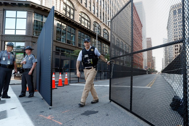 A United States Secret Service agent closes a security fence, as preparations are made for the Republican National Convention in Cleveland. (AP Photo/Alex Brandon)