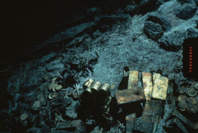 FILE - This 1989 file photo shows gold bars and coins from the S.S. Central America, a mail steamship, which sunk in a hurricane in 1857, about 160 miles off the North Carolina coast. Federal Judge Rebecca Beach Smith ruled Wednesday, July 9, 2014, that an Ohio company named Recovery Limited Partnership has salvage rights to the SS Central America. (AP Photo/File)