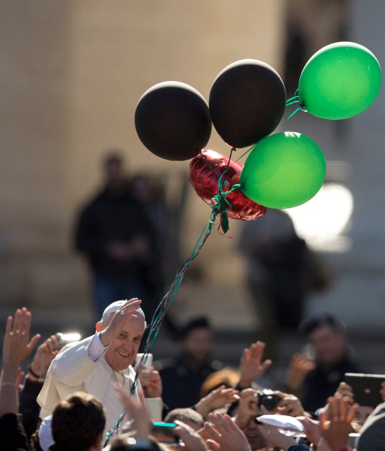 Pope Francis greets faithful as he leaves  St. Peter's Square at the Vatican, Friday, Feb. 14, 2014. Pope Francis met a group of engaged couples on Valentine's Day. (AP Photo/Alessandra Tarantino)