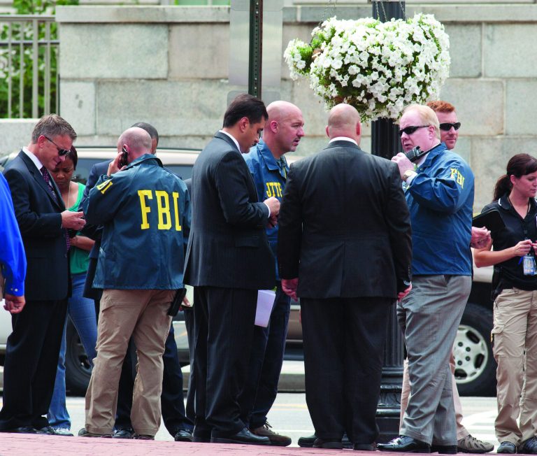 Washington Police and FBI agents gather outside the Family Research Council in Washington, Wednesday, Aug. 15, 2012, after security guard at the lobbying group was been shot in the arm. A police spokeswoman says the shooting happened Wednesday morning at the Family Research Council. Police say one person has been taken into custody. (AP Photo/J. Scott Applewhite)