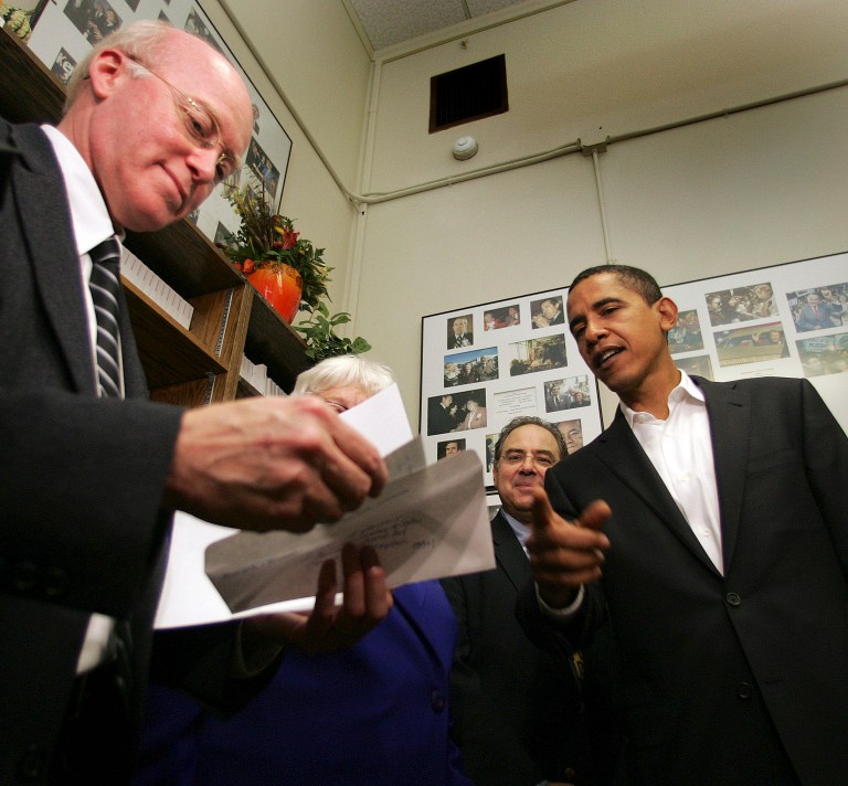 FILE - In this Monday Oct. 22, 2007 file photo, Secretary of State William Gardner, left, looks over Presidential Primary filing papers for then Democratic presidential hopeful, U.S. Sen Barack Obama, D-Ill.,right,  at the State house in Concord, N.H. Fifteen years ago Gardner and former Gov. Hugh Gregg teamed up to to teach college students with the then-novel idea of using the Internet. As the 2016 contest approaches, the University of New Hampshire plans to use the latest Internet technology to educate students far beyond its campus through a Massive Open Online Course exploring the state's treasured first-in-the-nation tradition. (AP Photo/Jim Cole, File)