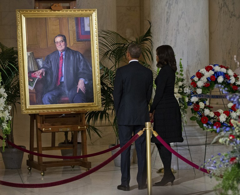 President Obama and first lady Michelle Obama stop to look at a portrait of Supreme Court Justice Antonin Scalia after paying their respects at Scalia's casket, Friday, Feb. 19, 2016. (AP Photo/Pablo Martinez Monsivais)
