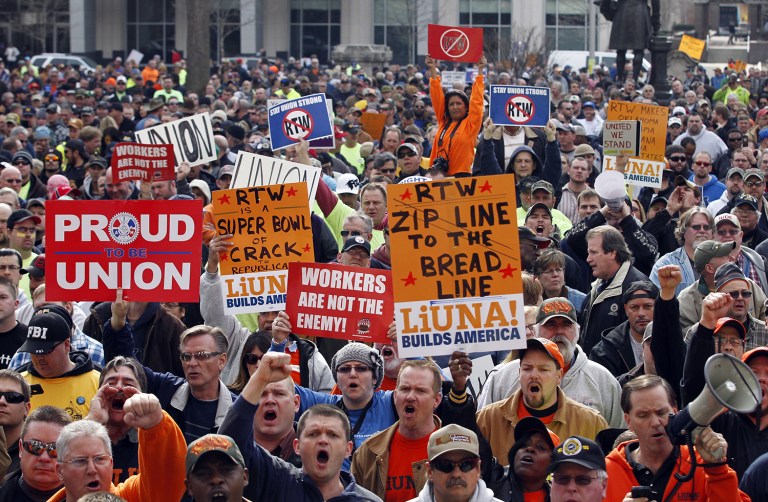 Right-to-work laws prohibit employees from being forced to either join the union or pay one a regular fee as a condition of employment. (AP Photo/Michael Conroy)