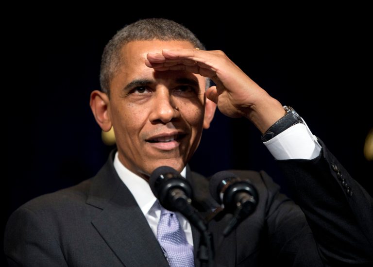 President Obama shields his eyes in an attempt to see a heckler who interrupted his speech at the general session of the Democratic National Committee winter meeting in Washington on Friday. (AP Photo/Pablo Martinez Monsivais)