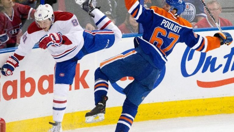 Montreal Canadiens Lars Eller (81) is checked by Edmonton Oilers Benoit Pouliot (67) during third period NHL hockey action in Edmonton, Alberta. AP Photo