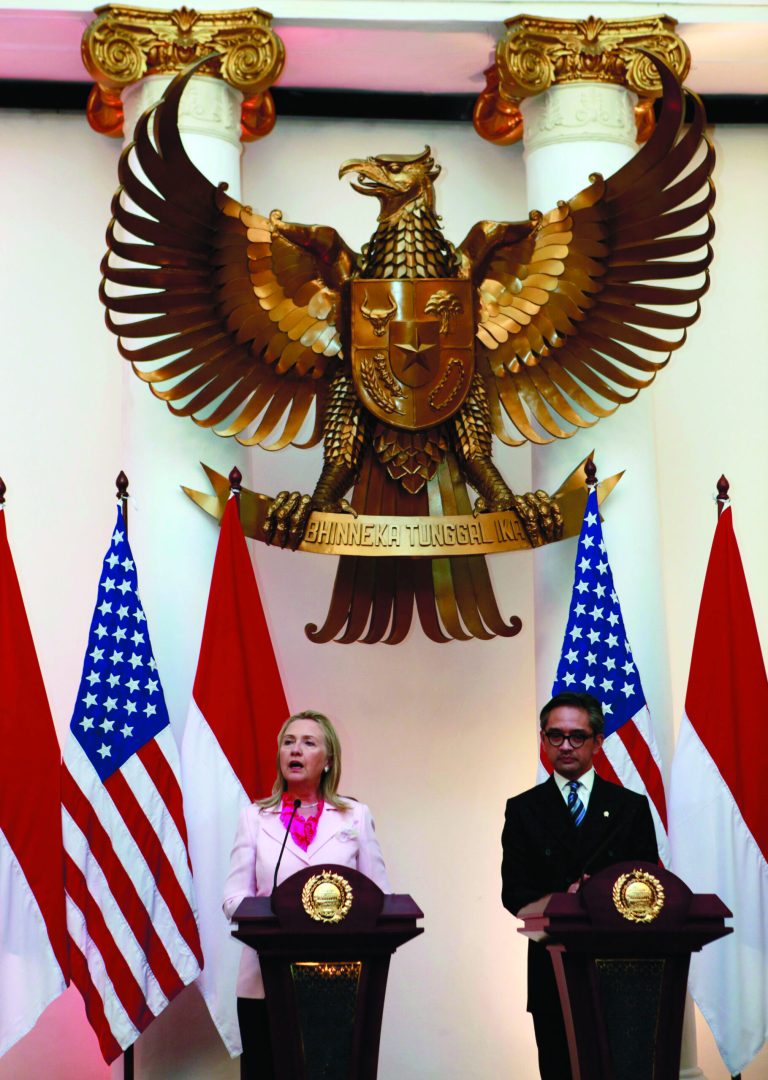 US Secretary of State Hillary Rodham Clinton, left, talks to the media as Indonesian Foreign Minister Marty Natalegawa listens during a press conference after their meeting in Jakarta, Indonesia, Monday, Sept. 3, 2012. (AP Photo/Dita Alangkara)
