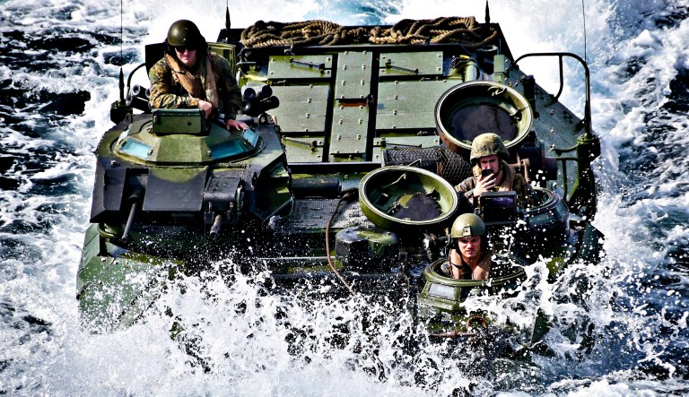 An assault amphibious vehicle (AAV), assigned to the 31st Marine Expeditionary Unit (MEU), approaches the well deck of the amphibious assault ship USS Wasp (LHD 1) in the Philippine Sea, Jan. 14, 2019.
