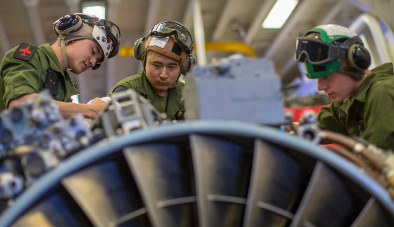 190510-M-EC058-0340 PACIFIC OCEAN (May 10, 2019) U.S. Marines with Marine Medium Tiltrotor Squadron (VMM) 163 (Reinforced), 11th Marine Expeditionary Unit (MEU), perform maintenance on an AV-8B Harrier engine aboard the amphibious assault ship USS Boxer (LHD 4). The Marines and Sailors of the 11th MEU are conducting routine operations as part of the Boxer Amphibious Ready Group.