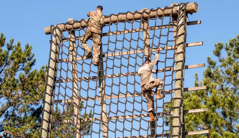 U.S. Army Soldiers assigned to 3rd Brigade Combat Team, 10th Mountain Divsion climbs down a rope ladder on the first station of the air assault obstacle course during the 10th Mountain Division Light Fighters School Air Assault Course at Fort Polk, Louisiana, June 7, 2019. Candidates wishing to obtain the coveted Air Assault Badge must successfully complete a majority of the nine stations of the air assault obstacle course.
