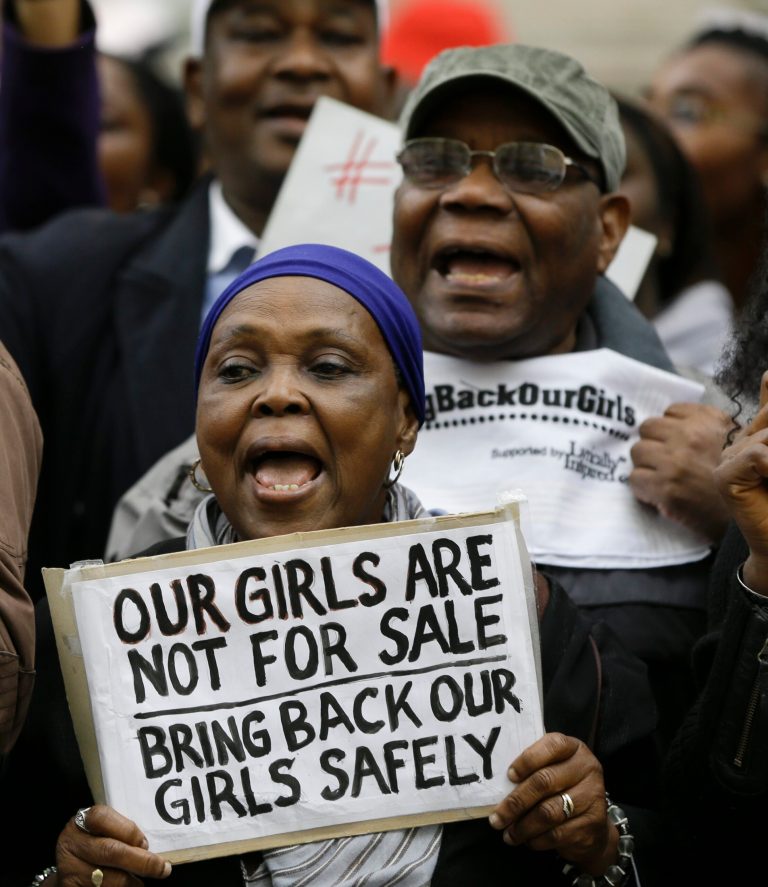 Demonstrators hold banners as they protest about the kidnapping of girls in Nigeria, near the Nigerian High Commission in London, Friday, May 9, 2014. Global outrage against the abduction of more than 200 Nigerian girls by Islamist militant sect Boko Haram heated up Thursday, as a social media campaign drew worldwide support. (AP Photo/Kirsty Wigglesworth)