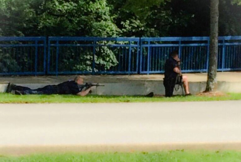 Authorities work an active shooting scene on amincola highway near the Naval Reserve Center, in Chattanooga, Tenn. on Thursday, July 16, 2015. Chattanooga Mayor Andy Berke says police are pursuing an active shooter after reports of a shooting at the military reserve center. (WRCB-TV via AP)