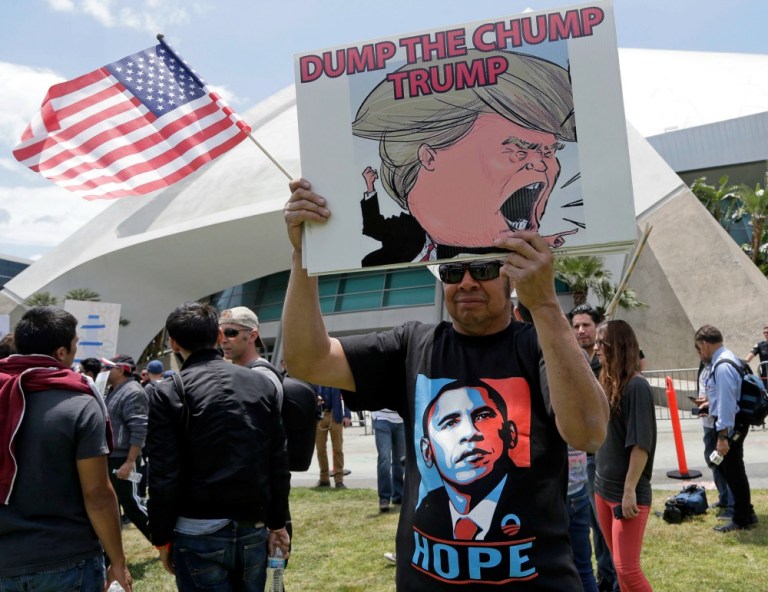 Anti-Trump protesters and immigrants right activists, some of whom were waving Mexican flags, gathered outside the billionaire's rally, joined in a collective 
