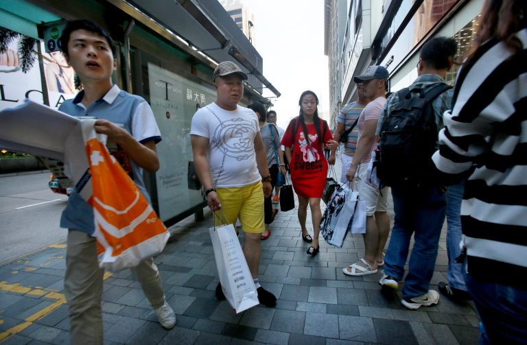 Hong Kong protesters try to win over tourists