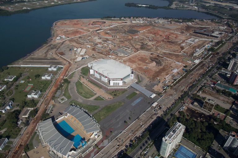 This June 27, 2014 aerial view photo shows Olympic Park under construction in an area previously occupied by the Jacarepagua Autodrome, and the nearby athlete village in Rio de Janeiro, Brazil. Brazil has just pulled off the World Cup. Now the tough work begins: preparing Rio de Janeiro's 2016 Olympics, which is an even larger challenge than football's big event. (AP Photo/Leo Correa)