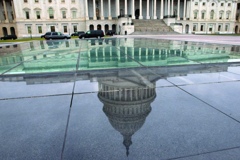 FILE - In this Tuesday, Jan. 1, 2013, file photo, the dome of the Capitol is reflected in a skylight of the Capitol Visitor's Center in Washington. By delaying hard choices on spending, the fiscal cliff deal guaranteed more confrontation and uncertainty this year, especially when Congress must vote later this winter to raise the government's borrowing limit. That's likely to keep businesses cautious about hiring and investing. (AP Photo/Jacquelyn Martin, File)