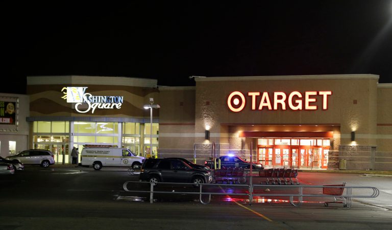 Police stand outside of the entrance at the Washington Square Mall on Wednesday, Oct. 28, 2015, in Indianapolis. Indianapolis police responded to a report of multiple people shot at the shopping mall. (AP Photo/Darron Cummings)