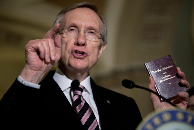 Senate Majority Leader Harry Reid holds a copy of the US Constitution while speaking to reporters after a meeting with Senate Democrats on Capitol Hill December 16, 2010 in Washington, DC. (Photo by Brendan Smialowski/Getty Images)
