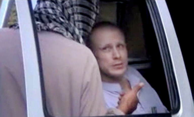 A Taliban fighter speaks to Sgt. Bowe Bergdahl, in eastern Afghanistan. The Taliban on Wednesday, June 4, 2014 released a video showing the handover of Bergdahl to U.S. forces in eastern Afghanistan, touting the swap of the American soldier for five Taliban detainees from Guantanamo as a significant achievement for the insurgents. (AP Photo/Voice Of Jihad Website via AP video)