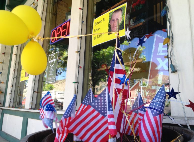 Flags and balloons marking the release from captivity of Sgt. Bowe Bergdahl adorn the sidewalk outside a shop in the soldier's hometown of Hailey, Idaho, Wednesday, June 4, 2014.  The exchange for five Taliban detainees from Guantanamo and the still-murky circumstances of how Bergdahl came to be captured nearly five years ago have prompted a fierce debate in Washington and across the country. (AP Photo/Brian Skoloff)