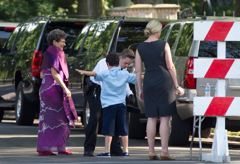   Members of the U.S. Secret Service scan guests arriving to Laura Jarrett's wedding, Saturday, June 16, 2012, in Chicago. Laura Jarrett is the daughter of Valerie Jarrett, senior adviser to President Barack Obama. President Obama and his family are attending the wedding. (AP Photo/Carolyn Kaster)  
