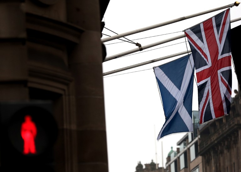 A Saltire and Union Jack flag hang side by side on a building in Edinburgh, Scotland, Friday, Sept. 19, 2014. Scottish voters have rejected independence and decided that Scotland will remain part of the United Kingdom. The result announced early Friday was the one favored by Britain's political leaders, who had campaigned hard in recent weeks to convince Scottish voters to stay. It dashed many Scots' hopes of breaking free and building their own nation. (AP Photo/Scott Heppell)