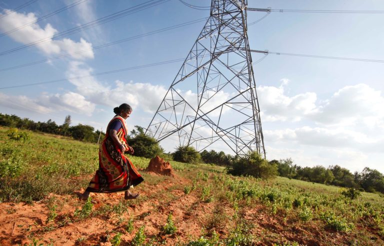   In this Dec. 5, 2012 photo, Gangarangamma, 65, walks through the land she and her husband farmed for decades which the records show is registered to the government, a sign the land remained in dispute, in village Karadigere Kaval, 85 kilometers (53 miles) from Bangalore, India. For years, Karnataka's land records were a quagmire of disputed, forged documents maintained by thousands of tyrannical bureaucrats who demanded bribes to do their jobs. In 2002, there were hopes that this was about to change. (AP Photo/Aijaz Rahi)  